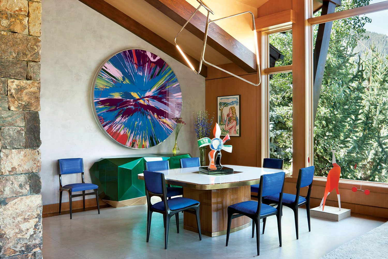 A Damien Hirst spin painting in the dining area of Sue Hostetler’s Aspen home designed by Sara Story.