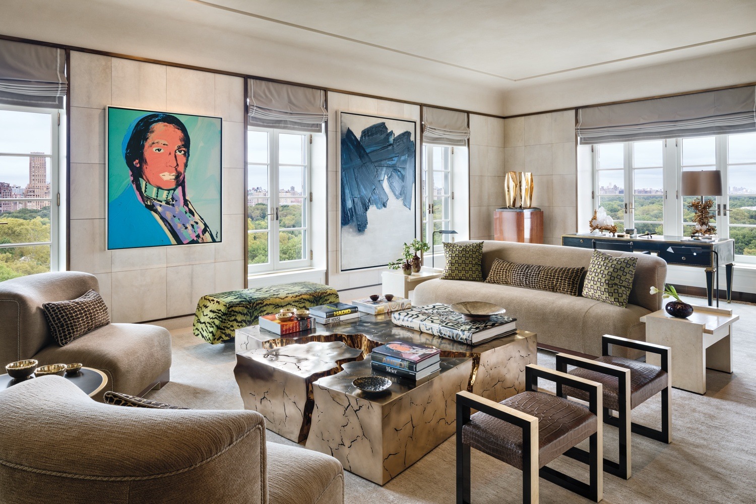 In this living room, designed by Deborah Berke and Christine van Deusen, paintings by Andy Warhol and Pierre Soulages overlook a seating area that includes pieces by Achille Salvagni, Jacques Adnet, and Based Upon. Also in the room are a Barbara Hepworth sculpture, Marc du Plantier desk, and Claude Boeltz lamp.
