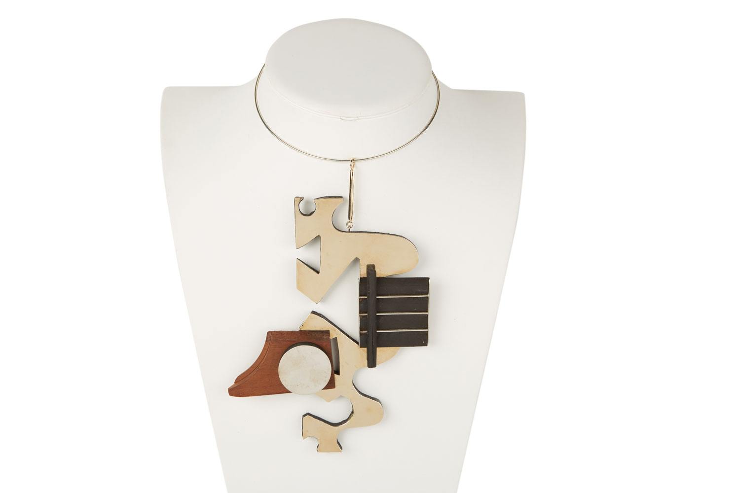 Louise Nevelson, Large pendant and torque, circa 1976–1977. The pendant is formed from four separate pieces of wood (circle, section of dowel, piece of molding, and a cut scrap of teak).