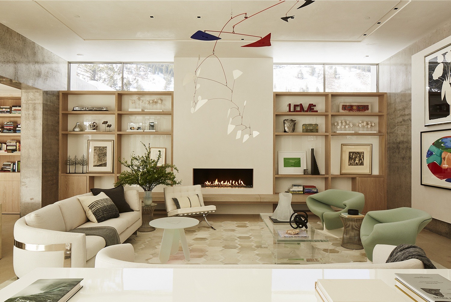 The living room in this Michael Imber-designed home was produced around a massive Alexander Calder mobile, while a floating wall was installed to display works by Donald Sultan and Tom Wesselmann from the homeowner’s collection.