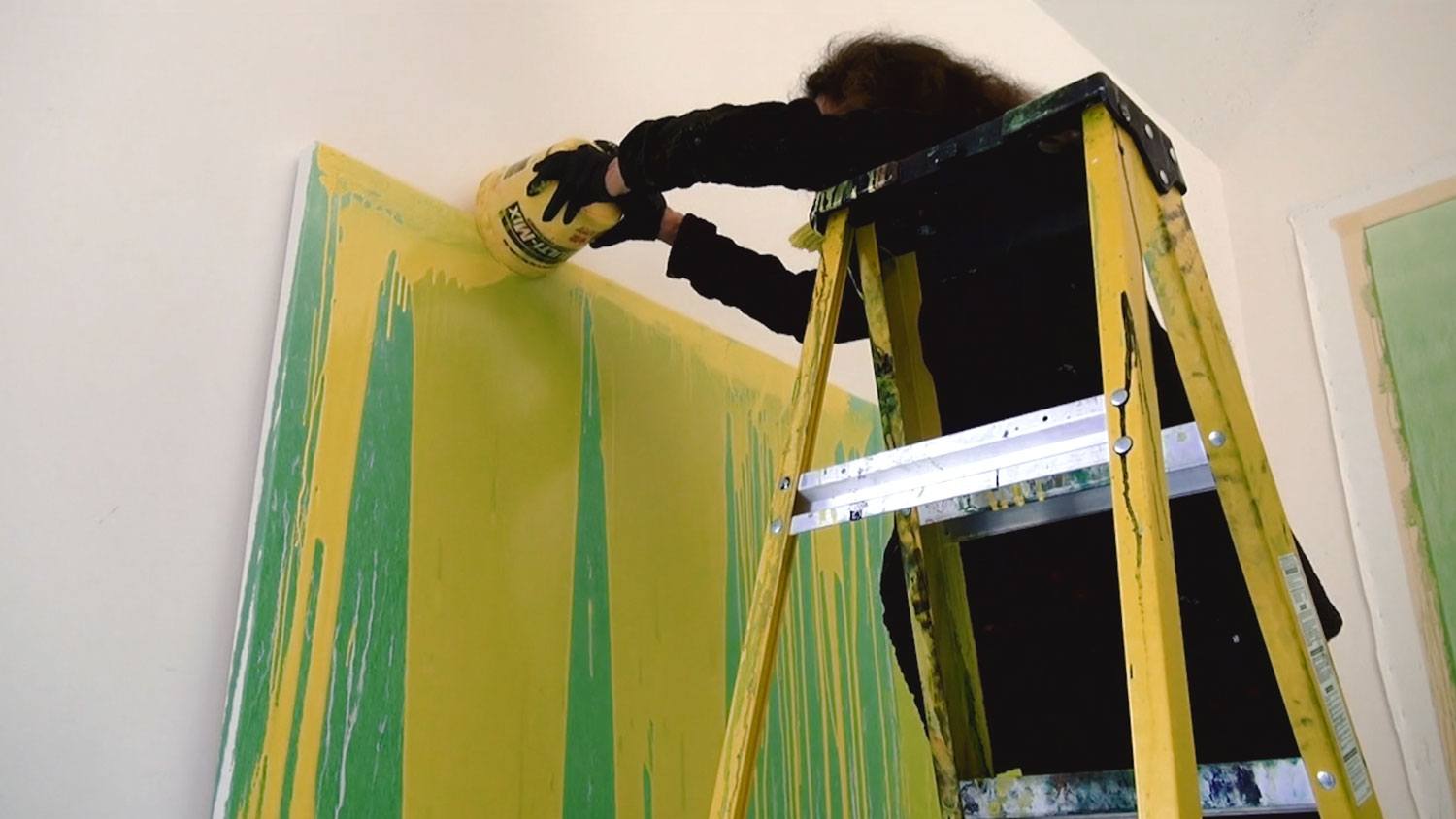 Pat Steir pouring paint in her studio